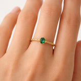 BRAIDED RING WITH EMERALD HENE