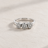 THREE-ROSETTE RING WITH ILLUSION-SETTING DIAMONDS IN PRONGS