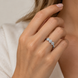THREE-ROSETTE RING WITH ILLUSION-SETTING DIAMONDS IN PRONGS