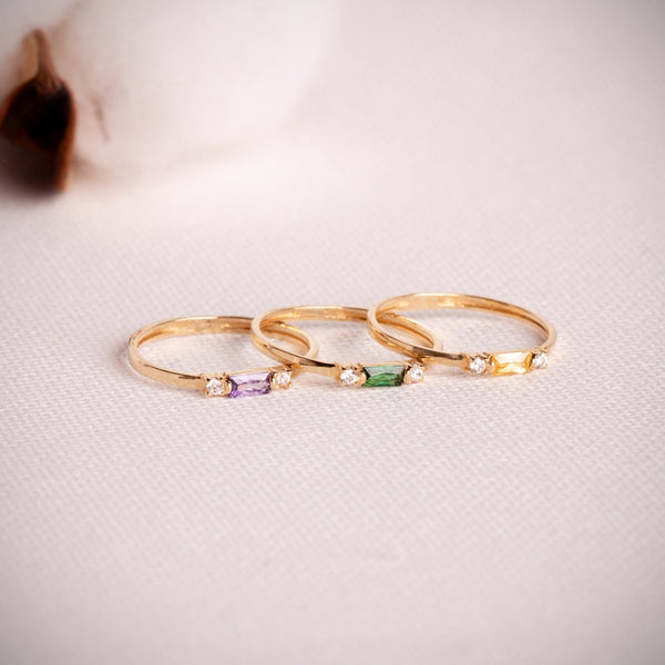 Thin vertical ring with green and white cubic zirconia stones