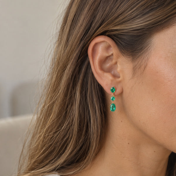 Long earrings with oval and round emeralds