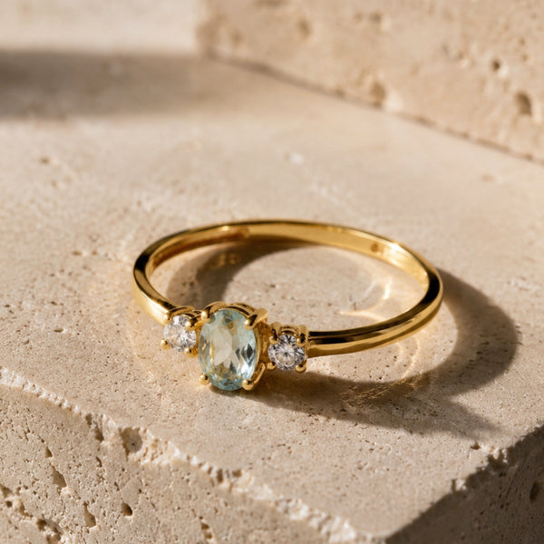 ANILLO AGUAMARINA OVAL CENTRAL Y CIRCONITAS