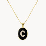 COLGANTE OVAL INICIAL CON DIAMANTES Y ONIX