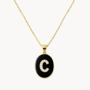 COLGANTE OVAL INICIAL CON DIAMANTES Y ONIX