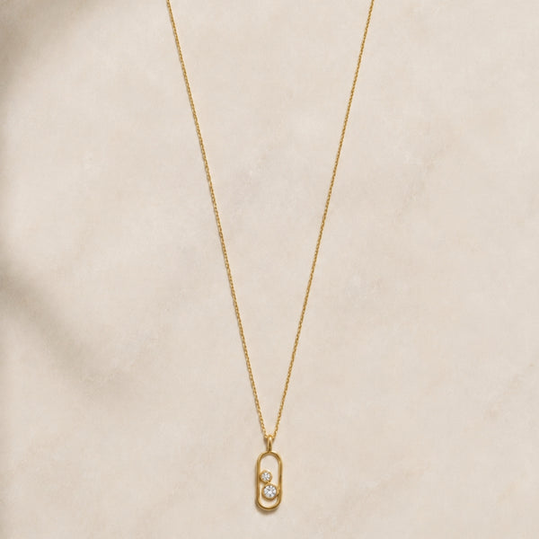 Oval pendant with two diamonds in a chaton setting