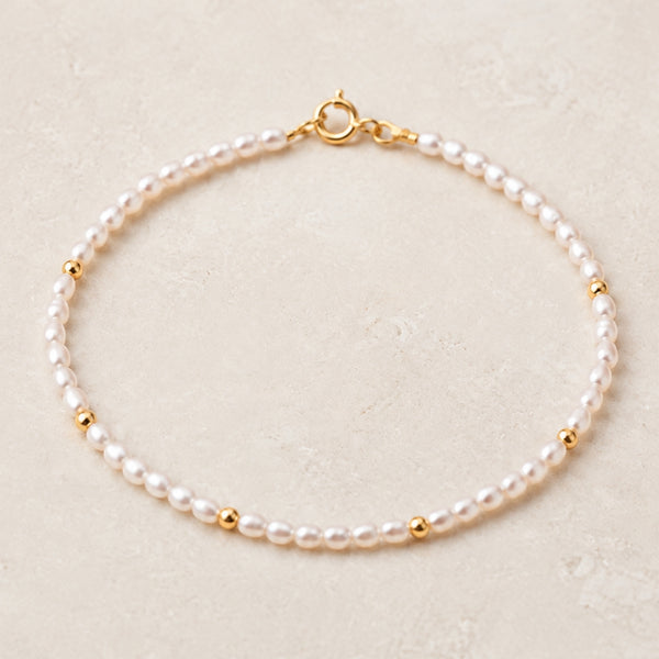 PULSERA CON PERLAS DE GRANO Y BOLAS DE ORO